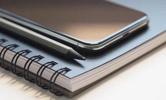Notebook, pen and phone